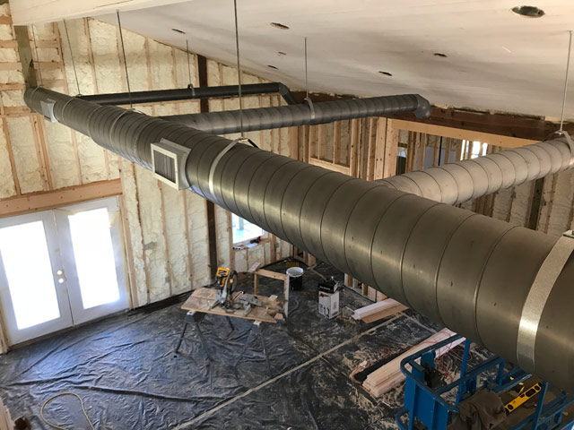 Exposed spiral duct in residential home for a industrial look